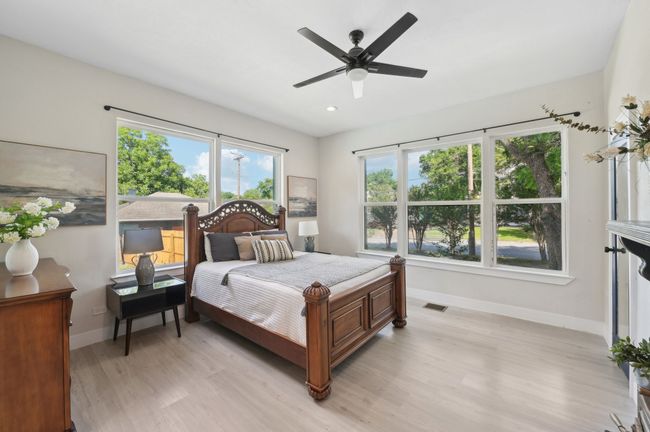 Bedroom featuring baseboards, light wood finished floors, multiple windows, recessed lighting, and ceiling fan | Image 29