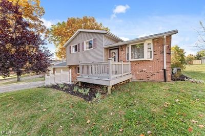 Split level home featuring a front yard and a deck | Image 2