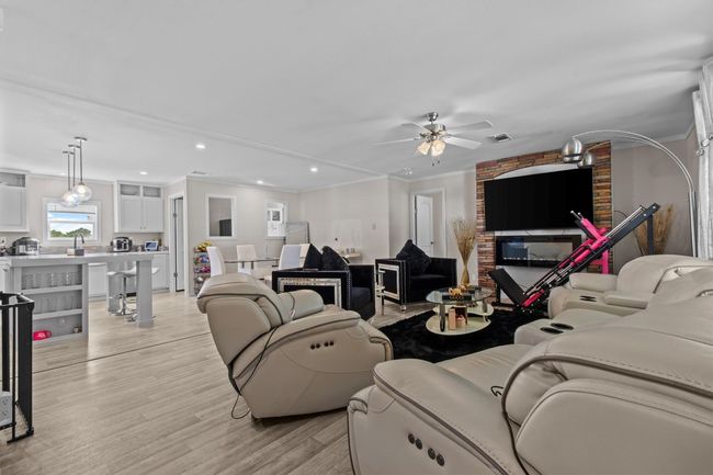 The centerpiece is a spacious 2, 061 sq ft manufactured home, just 1.5 years old, with 4 bedrooms, 2 bathrooms, and a beautifully crafted 40' x 20' stone outdoor kitchen under a covered roof with lighting—ideal for hosting under the stars. | Image 6