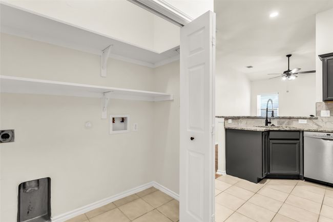Laundry room featuring washer hookup, electric dryer hookup, light tile patterned flooring, a ceiling fan, and recessed lighting | Image 10