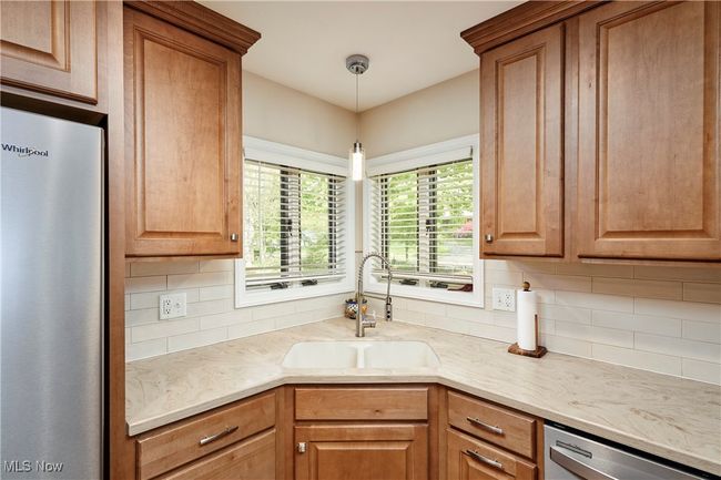 Kitchen featuring stainless steel appliances, a sink, tasteful backsplash, and pendant lighting | Image 14