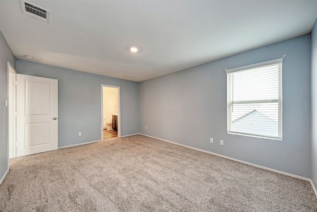 Unfurnished bedroom with carpet floors, baseboards, and connected bathroom | Image 18