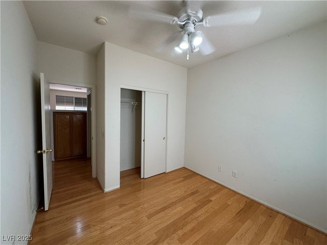 Unfurnished bedroom with light wood finished floors, a closet, baseboards, and a ceiling fan | Image 24