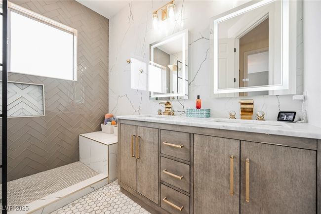 Full bath with tile patterned floors, double vanity, a tile shower, and a sink | Image 44