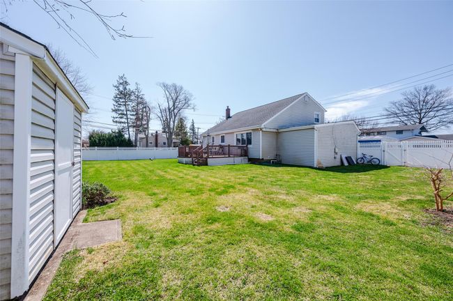 View of yard featuring a gate, a fenced backyard, and a deck | Image 22