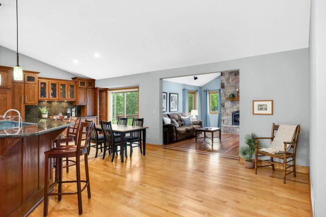 Step into this 5 BR / 3 BA Champlin home and immediately fall in love with the spacious layout, vaulted ceilings, and beautiful hardwood floors throughout. | Image 8