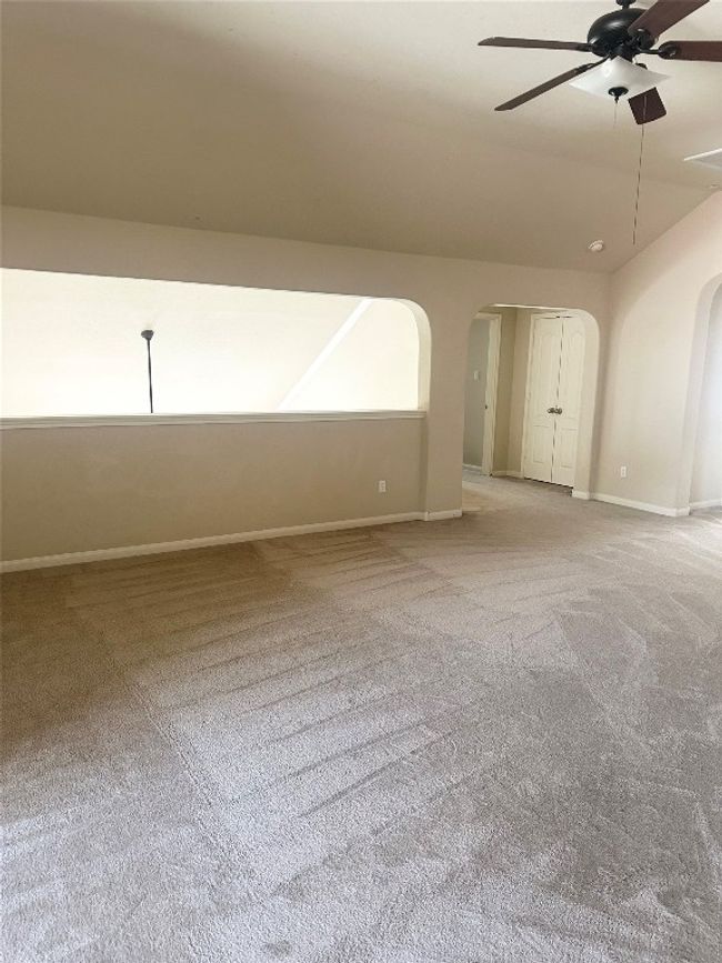 Spare room with arched walkways, light carpet, and ceiling fan | Image 8