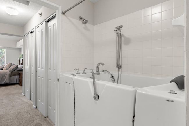 The walk-in bathtub/shower combo equipped with whirlpool jets and handrails for added convenience. | Image 11