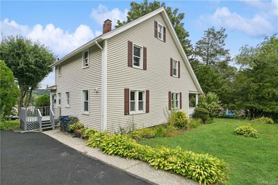 View of side of property with a deck and a lawn | Image 2