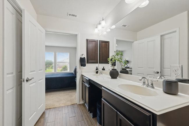 Ensuite Primary bathroom with a dual sinks, and luxury vinyl plank floors | Image 18