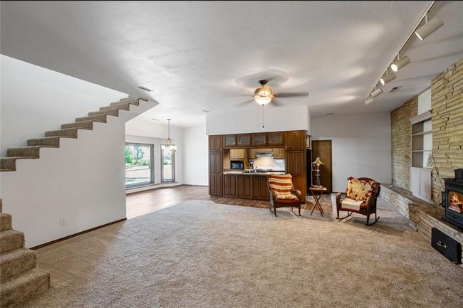 Carpeted bedroom featuring a textured ceiling, visible vents, ceiling fan, and baseboards | Image 10