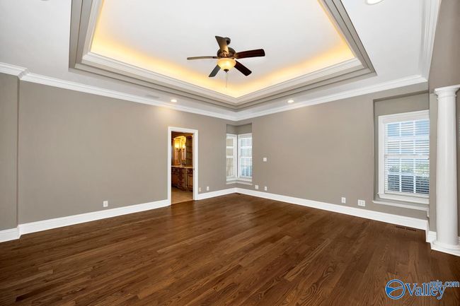 Wood flooring, crown molding, trey ceiling, ceiling fan, recessed lighting | Image 24