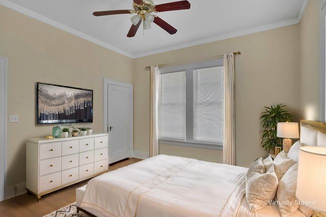 Bedroom with ornamental molding, wood finished floors, and a ceiling fan | Image 22