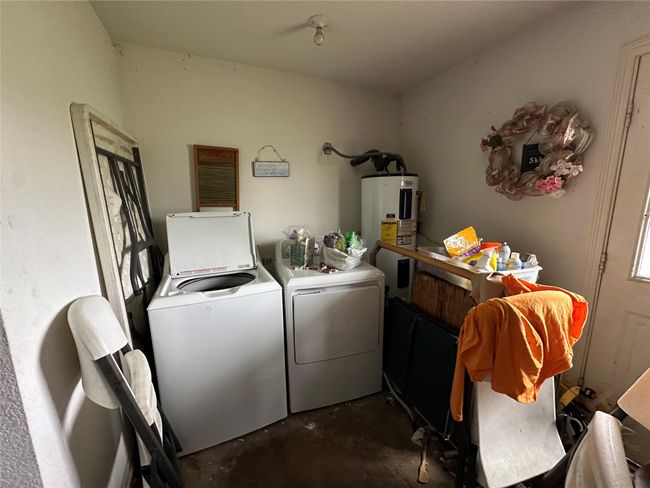 Laundry room featuring washer and clothes dryer and water heater | Image 15
