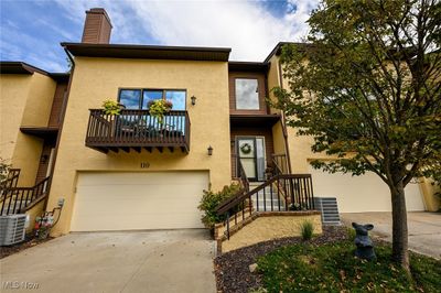 View of front of home featuring a balcony, a garage, and central air condition unit | Image 2