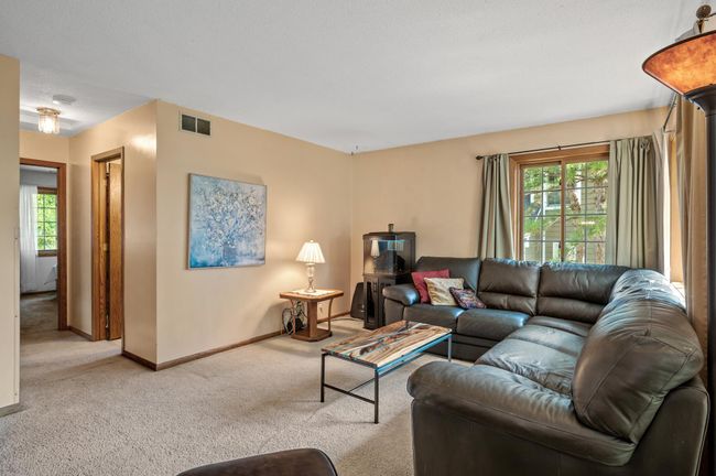 Great view of the living room and hallway that takes you to the 2 bedrooms on this level. | Image 7