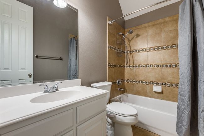 Bathroom with shower / tub combo, vanity, and toilet | Image 26