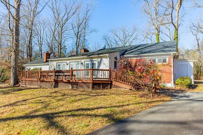 Sunroom and large deck compliment rear of home. | Image 3