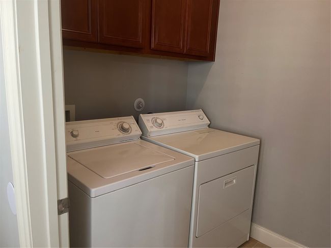 Laundry room featuring cabinet space and washing machine and dryer | Image 15