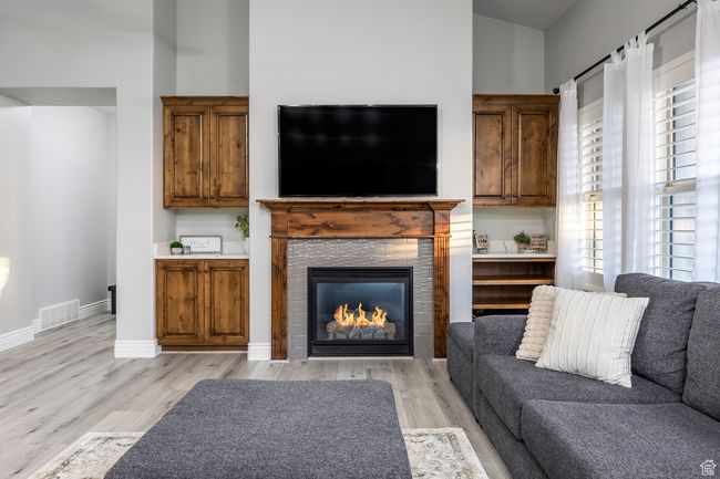 Living room featuring a tiled fireplace and light hardwood / wood-style floors | Image 4