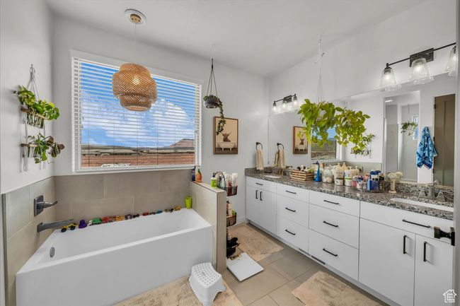 Full bathroom with double vanity, a sink, tile patterned floors, and a washtub | Image 19