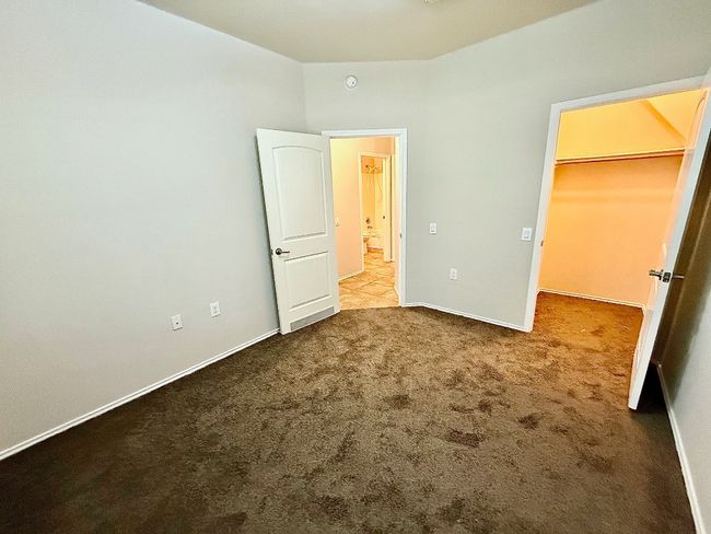 Unfurnished bedroom with carpet floors and baseboards | Image 15