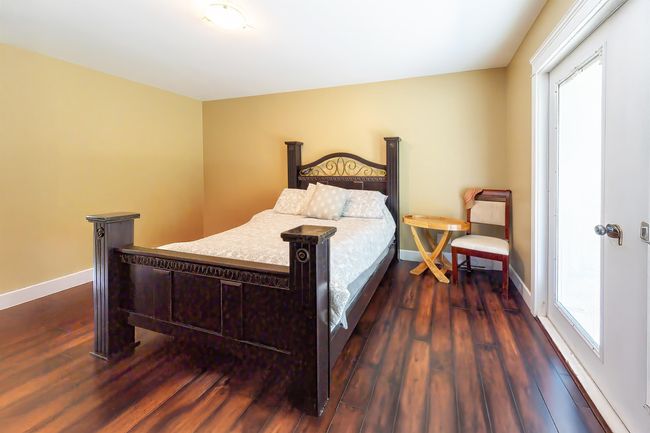 Bedroom featuring baseboards and dark wood-style flooring | Image 35
