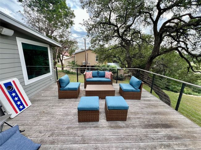 Spacious and inviting back patio deck, perfect for outdoor relaxation and entertaining. | Image 16