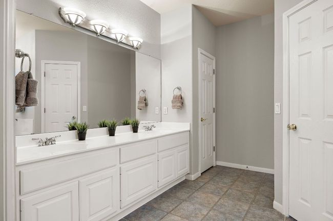 The primary bathroom offers dual vanities, a large soaking tub, a walk-in shower, and a large, walk-in​​‌​​​​‌​​‌‌​‌‌​​​‌‌​​‌‌​‌​​​​​‌ closet. | Image 11