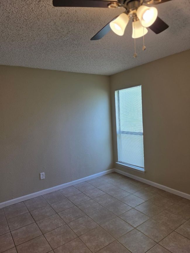 Tiled spare room with a ceiling fan and a textured ceiling | Image 12