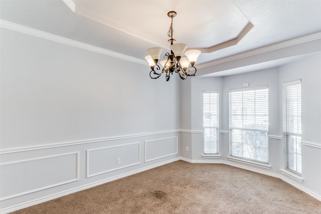 Carpeted empty room featuring a chandelier and crown molding | Image 5