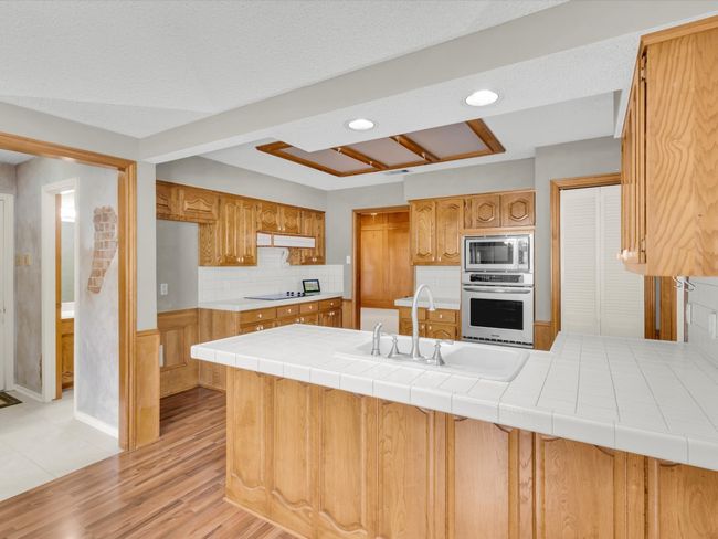 Kitchen opens to half bath and laundry room. | Image 21