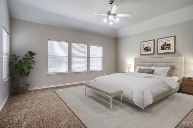 Bedroom with light carpet, baseboards, and ceiling fan | Image 10