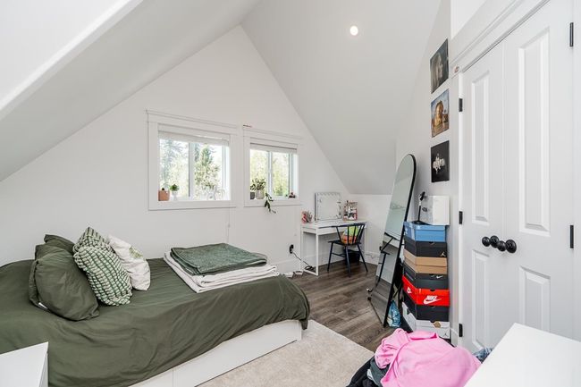 Bedroom featuring recessed lighting, wood finished floors, and vaulted ceiling | Image 21