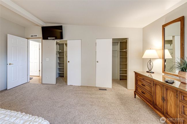 Dual walk-in closets with abundant shelving. | Image 25