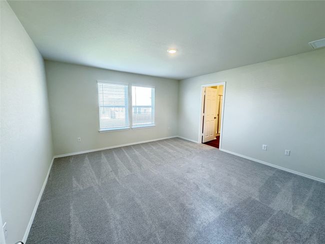 Empty room featuring dark colored carpet and baseboards | Image 11