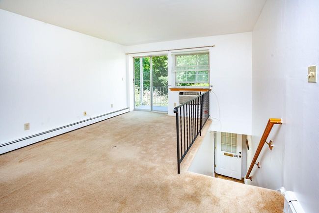 Livingroom featuring carpet floors and baseboard heating | Image 5