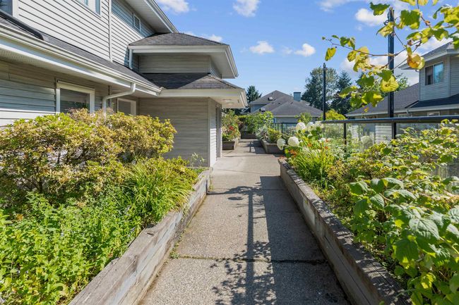 View of home's exterior with roof with shingles | Image 15