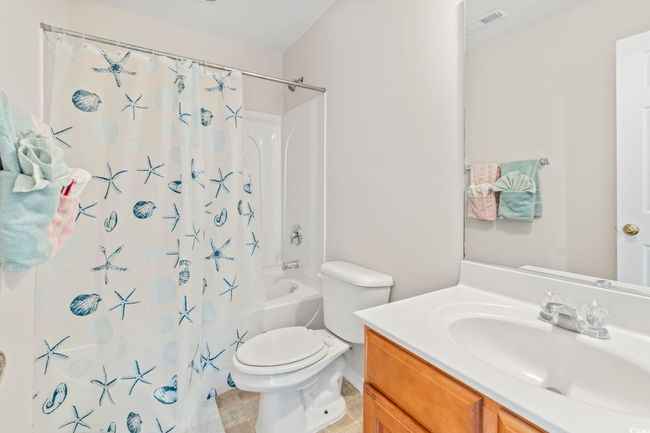 Bathroom with vanity, toilet, and shower / bath combo with shower curtain | Image 17