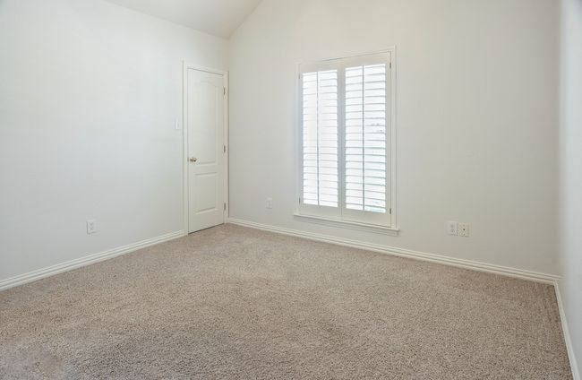 Carpeted spare room with plenty of natural light, and lofted ceiling | Image 20