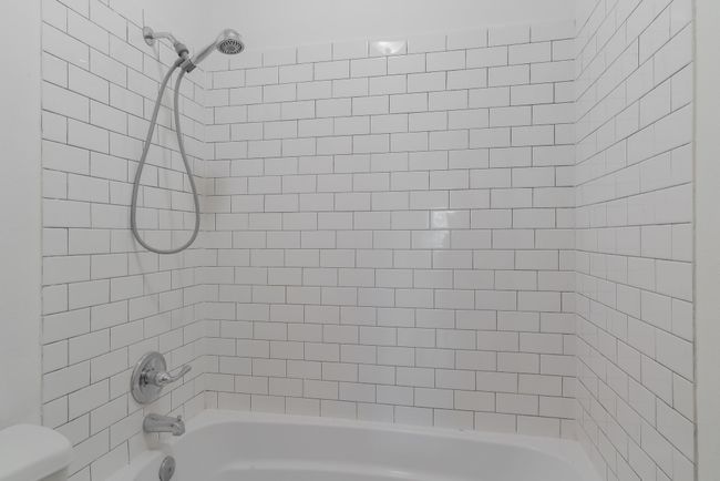 Bathroom featuring double vanity, a sink, a textured ceiling, and a closet | Image 29