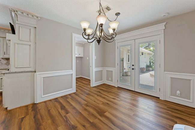 While dining, you can enjoy the inviting back yard through the lovely french doors. | Image 13
