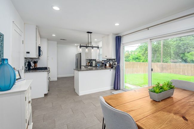 View looking from the dining area into the kitchen. | Image 12