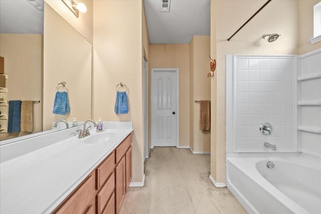 Full bathroom with vanity, shower / washtub combination, and baseboards | Image 28