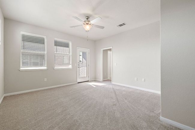 Empty room featuring light colored carpet, baseboards, and ceiling fan | Image 17