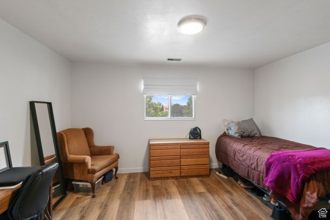 Bedroom with wood finished floors and baseboards | Image 9