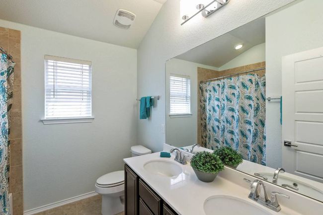 Full bath featuring lofted ceiling, double vanity, and a shower with curtain | Image 28