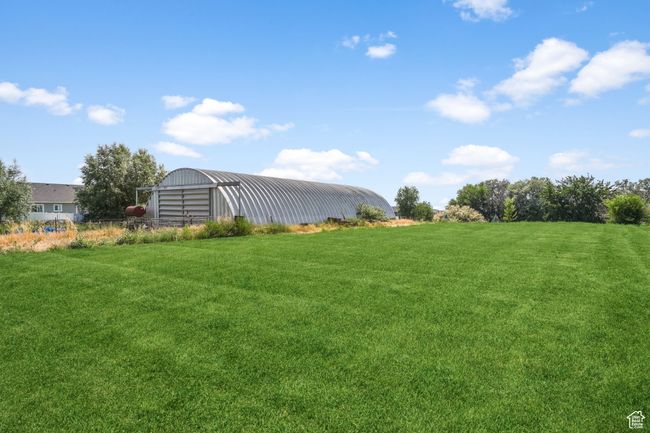 View of yard featuring an outdoor structure and a pole building | Image 32