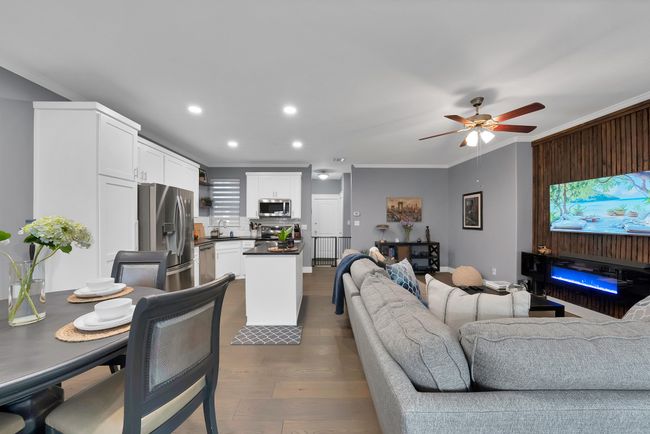 Living area with ornamental molding, wood finished floors, ceiling fan, and recessed lighting | Image 18