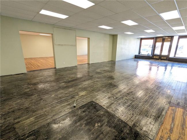 Unfurnished room with hardwood / wood-style flooring and a drop ceiling | Image 5